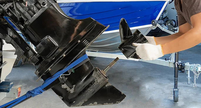 Outboard motor being serviced on a boat trailer